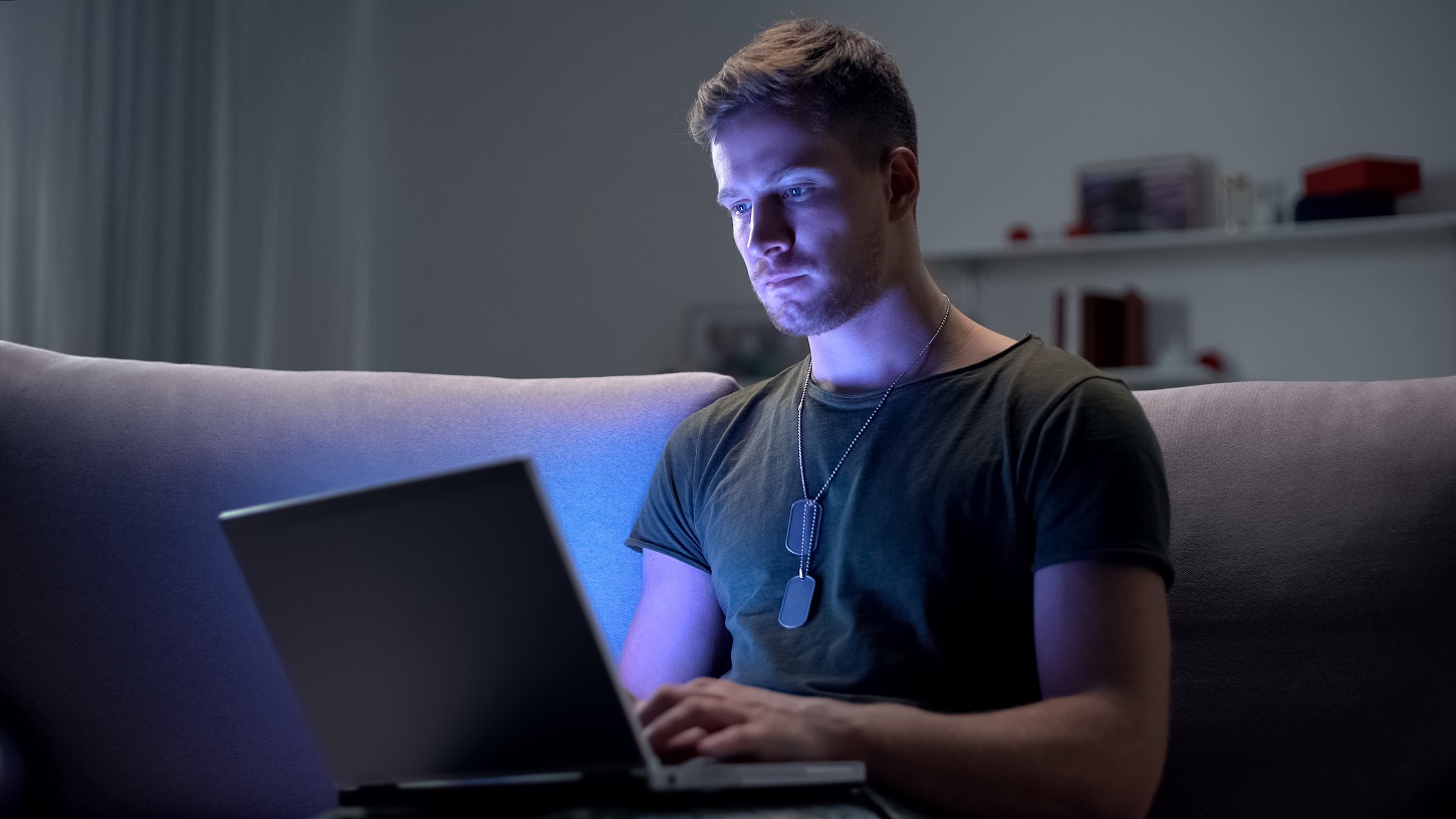 Serviceman searching job on laptop at home