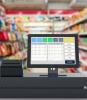 Closeup of cash register with grocery store aisles in background