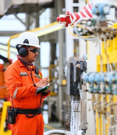 Operator recording operation of oil and gas process at oil and rig plant