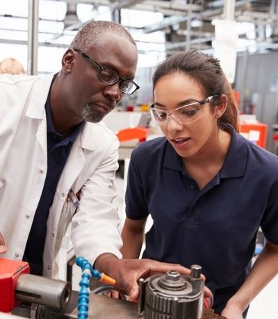 Engineer showing equipment to a female apprentice