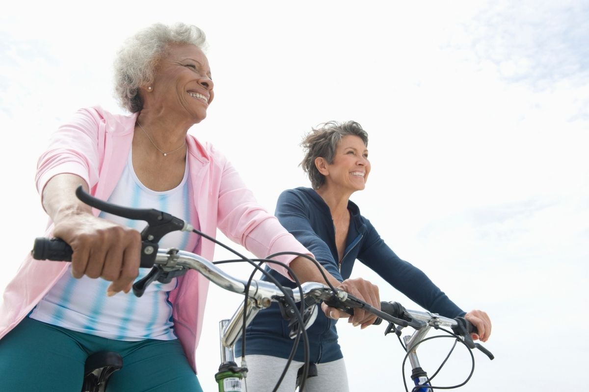 Senior female friends riding bicycles