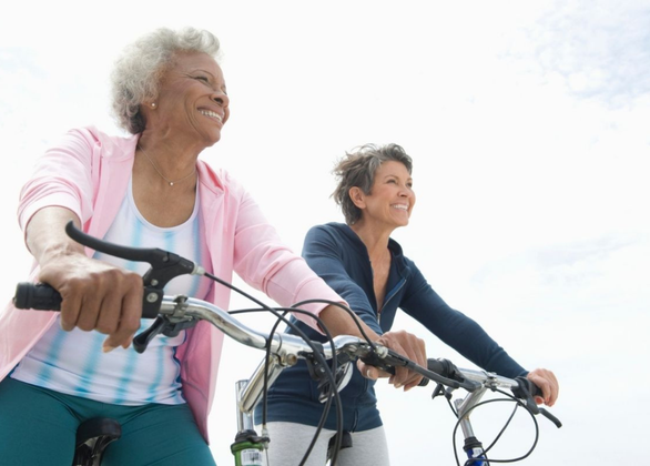 Senior female friends riding bicycles