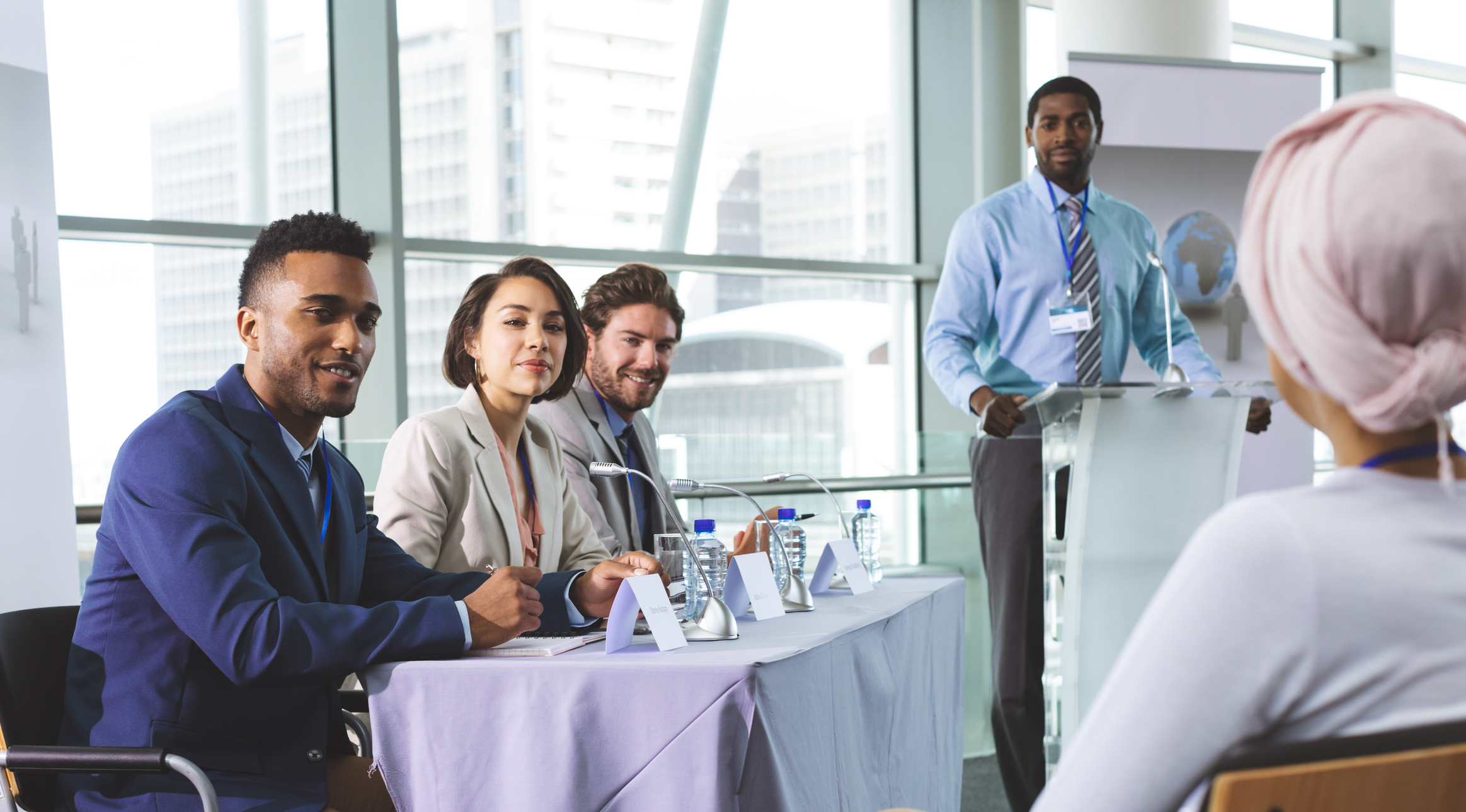 Five participants in a panel discussion setting