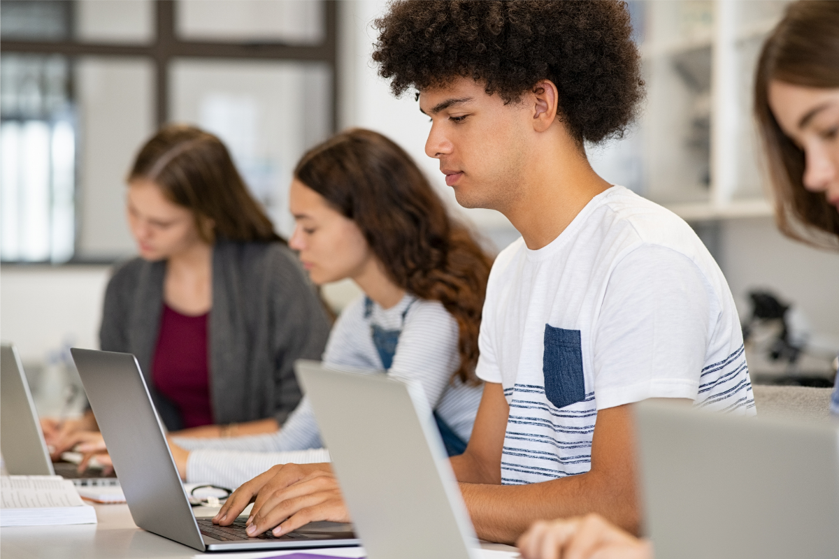 Students at desks working on laptops