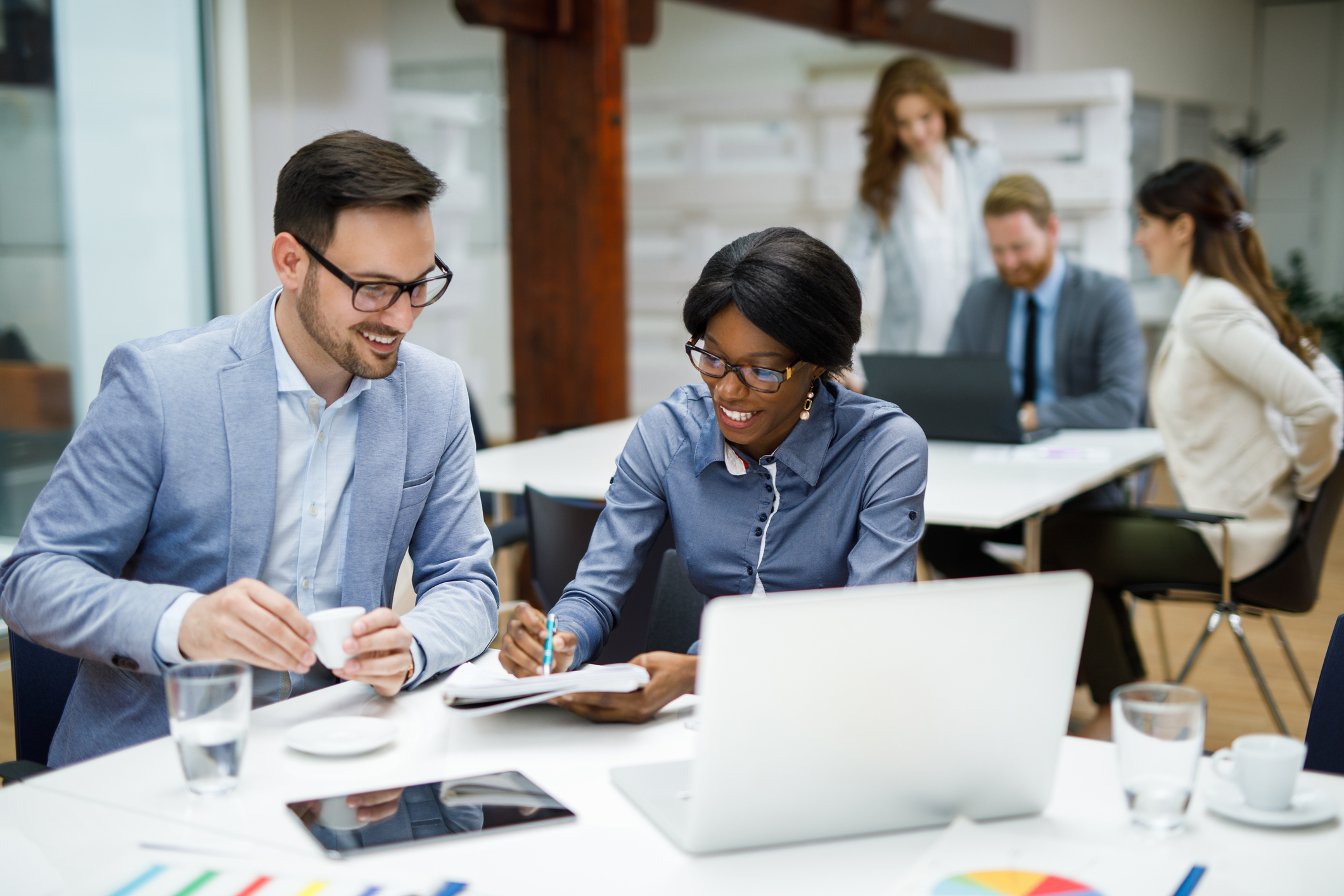 Two businesspeople reviewing business reports in the office.