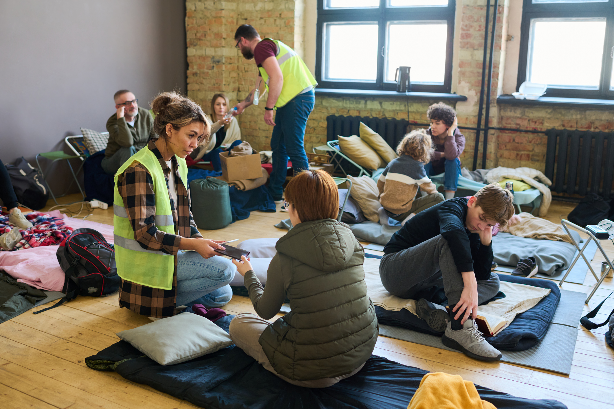 Workers helping people in a disaster shelter