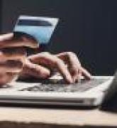 Man using laptop computer and credit card