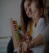 Mother and little cute girl playing with abacus