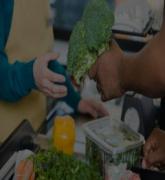 Customer handing a sales assistant broccoli