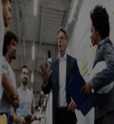 Company leader talking to employees while visiting a factory