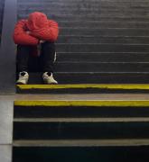 Young homeless man sleeping on the street