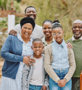 Portrait of a multigenerational family standing outside in the backyard