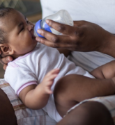 Father feeding his infant child