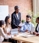 Group of people around a conference room table