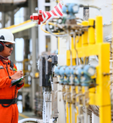 Operator recording operation of oil and gas process at oil and rig plant