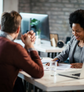 Woman counseling a couple at a desk
