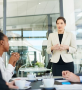 Colleagues discussing work around an office table 