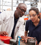 Engineer showing equipment to a female apprentice