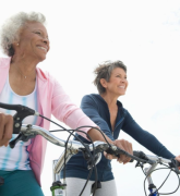 Senior female friends riding bicycles