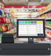 Closeup of cash register with grocery store aisles in background