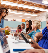 Teacher speaking to adult learners in a class